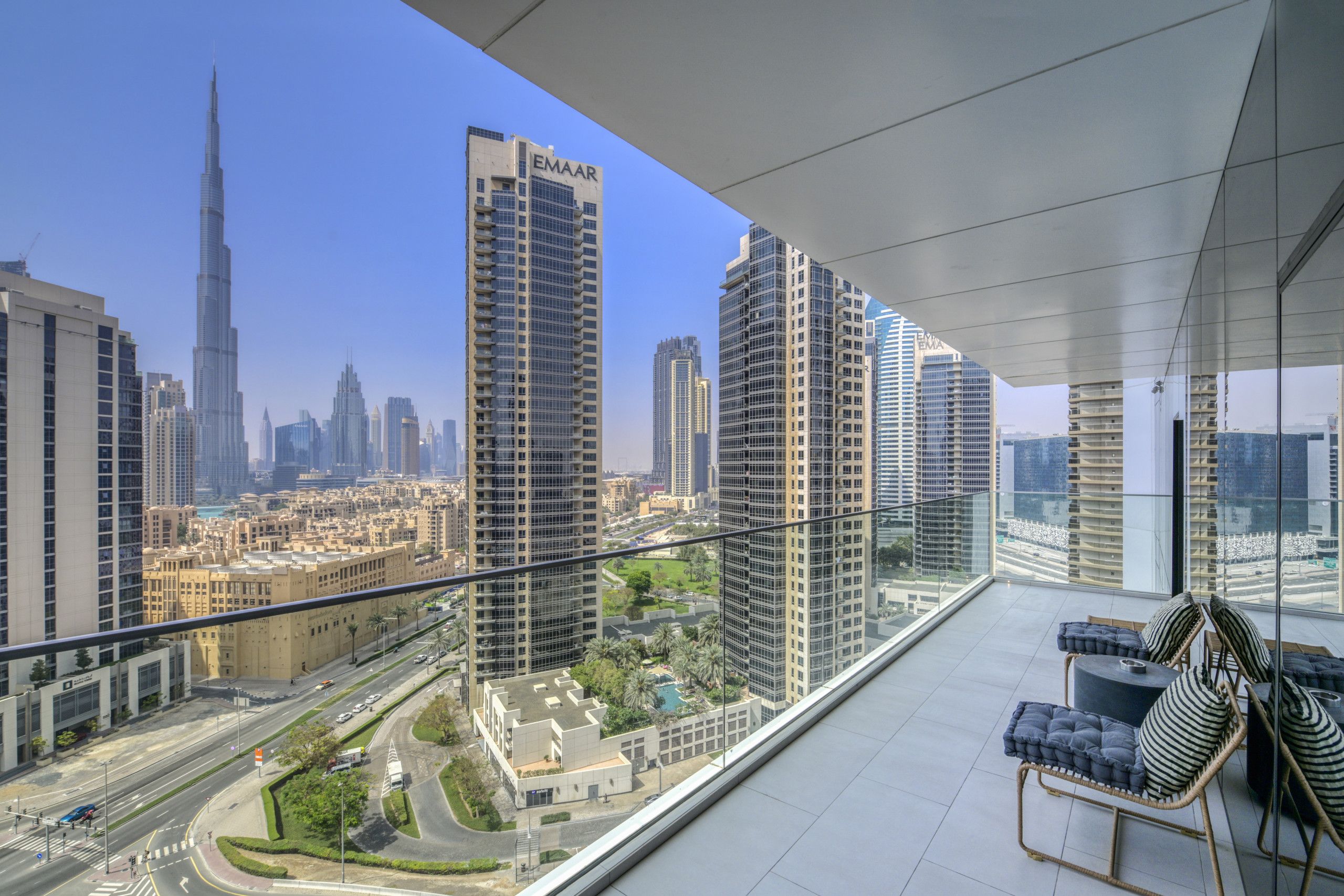 Ein Balkon mit Blick auf die Skyline, darunter hohe Gebäude und eine Straße.