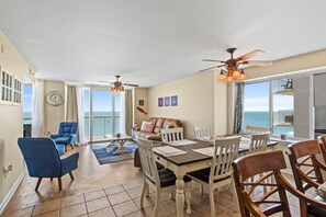 Relax in this inviting living area with a large dining table and comfortable seating for a perfect ocean view.