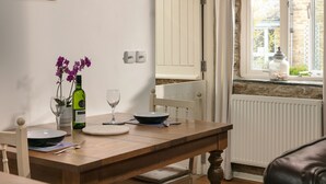 A dining table with a bowl, wine glass, and orchid vase. - 5* Idyllic rural cottage, only 20 minutes from both North & South Cornish coasts (Truro)