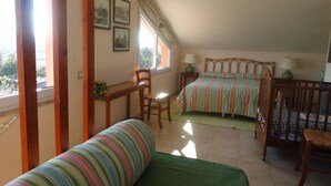 A bedroom with a bed, a chair, a small table, and a window. - 3-bedroom villa in fantastic Sassari with WiFi, AC (Sassari)
