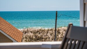 A beach view with a wooden structure and a utility pole. - Skipper's Hideout | Ocean Views + Walk to Beach! (North Topsail Beach)