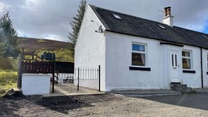 A white single-story house with a black roof, a chimney, and a small porch. - Cottage with Log Burner - Wanlockhead D & G (Wanlockhead)