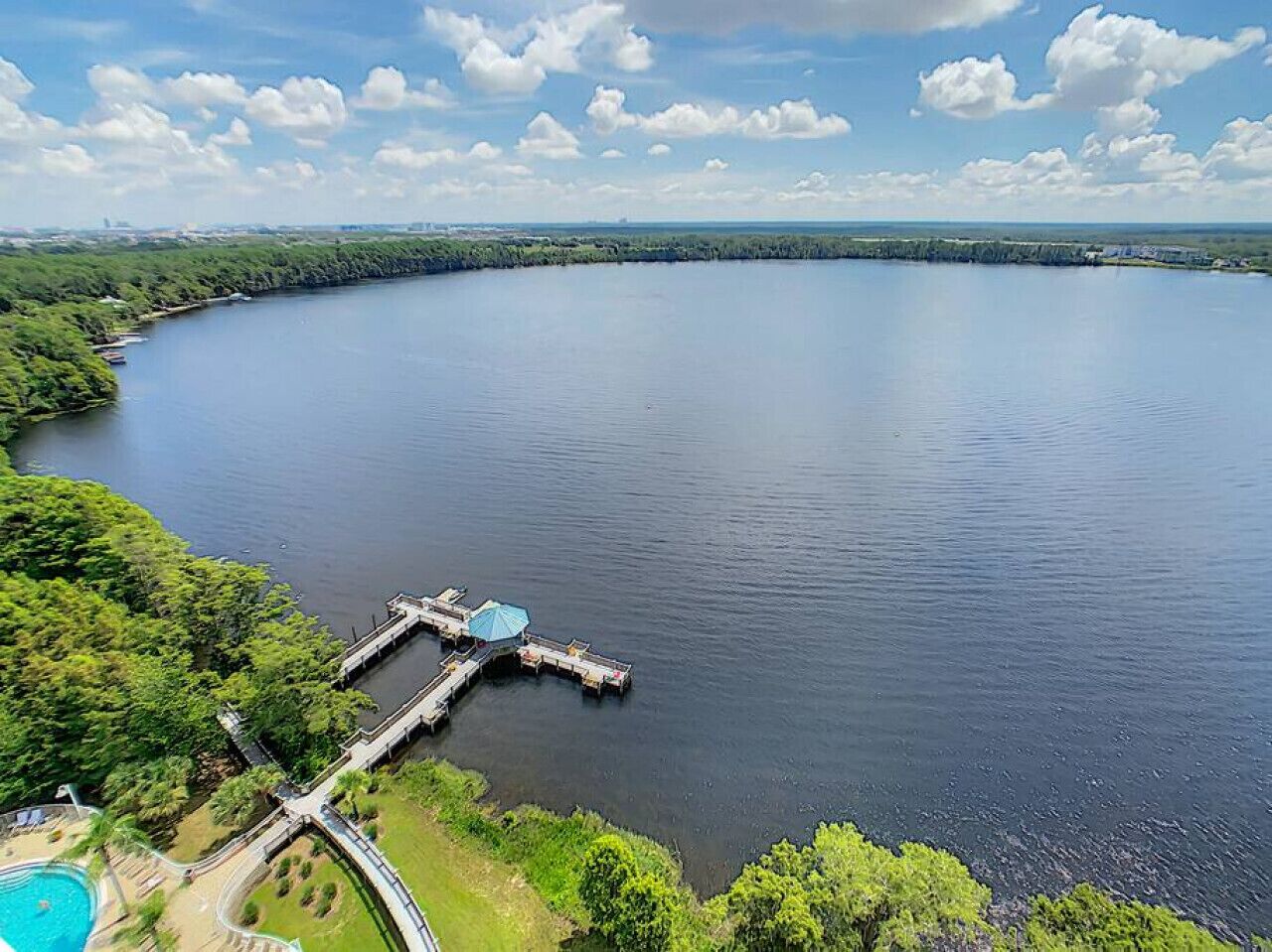 A large body of water with a dock extending into it.