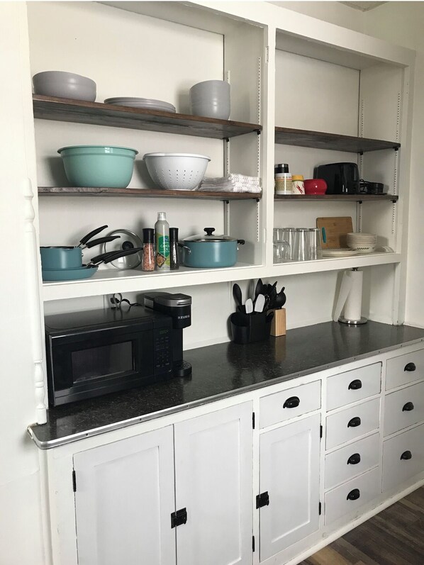 Kitchen area with microwave and coffee maker, plus ample storage for kitchen essentials.