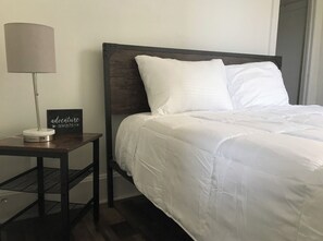 Restful retreat with a neatly made bed and a table for planning your next adventure.