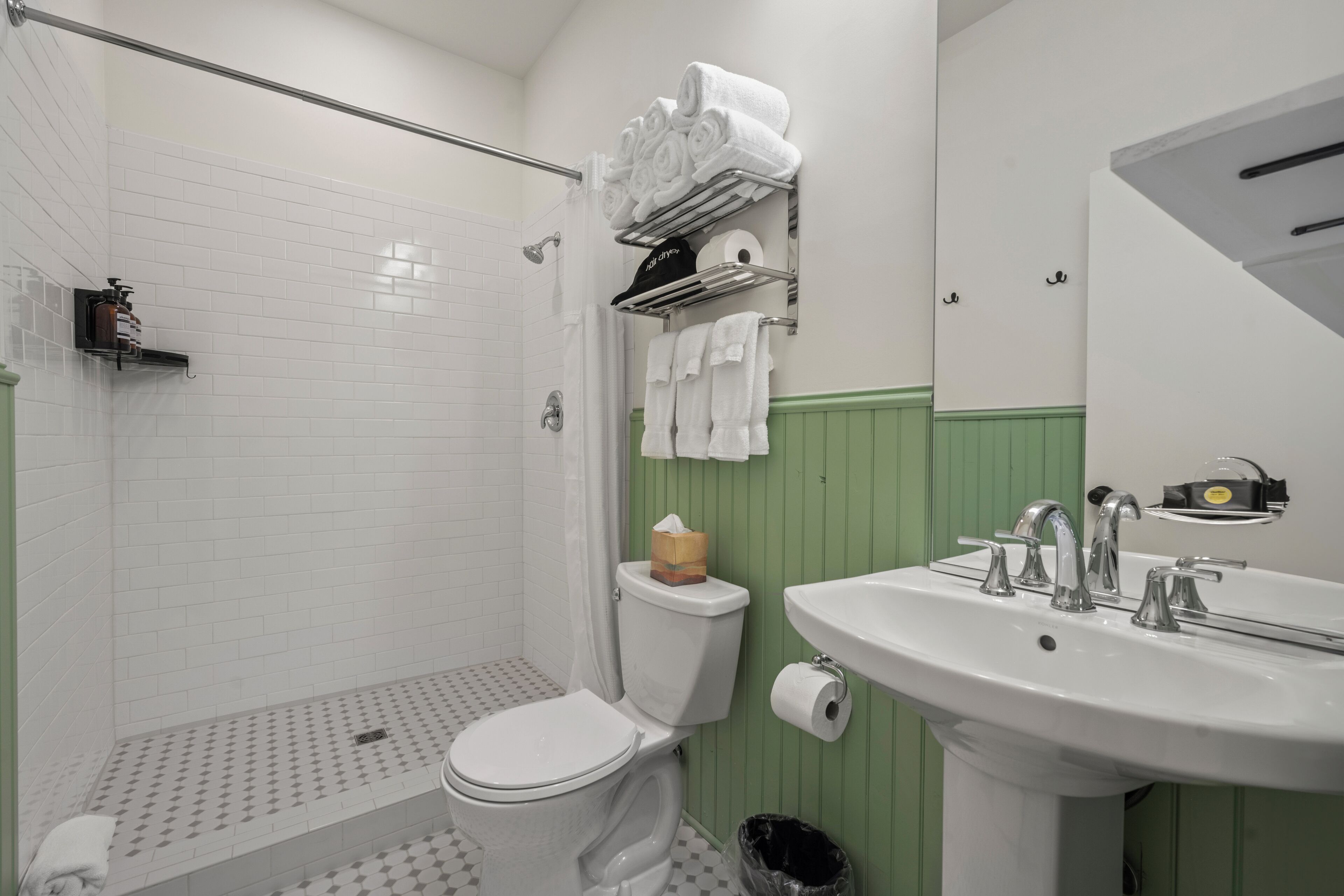 Un baño con inodoro, ducha y lavamanos.
