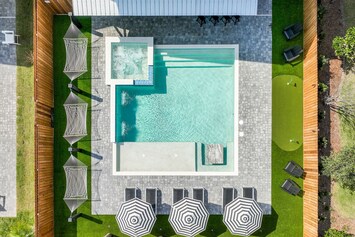 Poolside Hammocks, luxury lounges & umbrellas, poolside putting green 