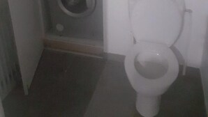 A small bathroom with a toilet, a washing machine, and a sink. - Great apartment! (Roques)