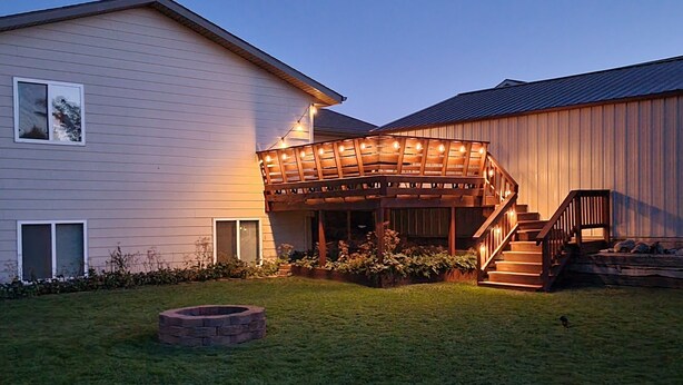 A house with a wooden deck, a fire pit, and a staircase leading to a covered porch. - Stage Stop Suite (Piedmont)