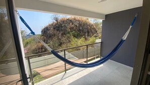 Ein Balkon mit einer blauen Hängematte.