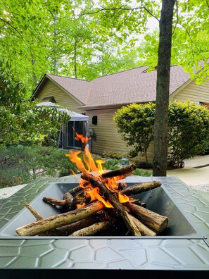 Enjoy a warm gathering by the fire pit surrounded by a beautifully maintained garden.