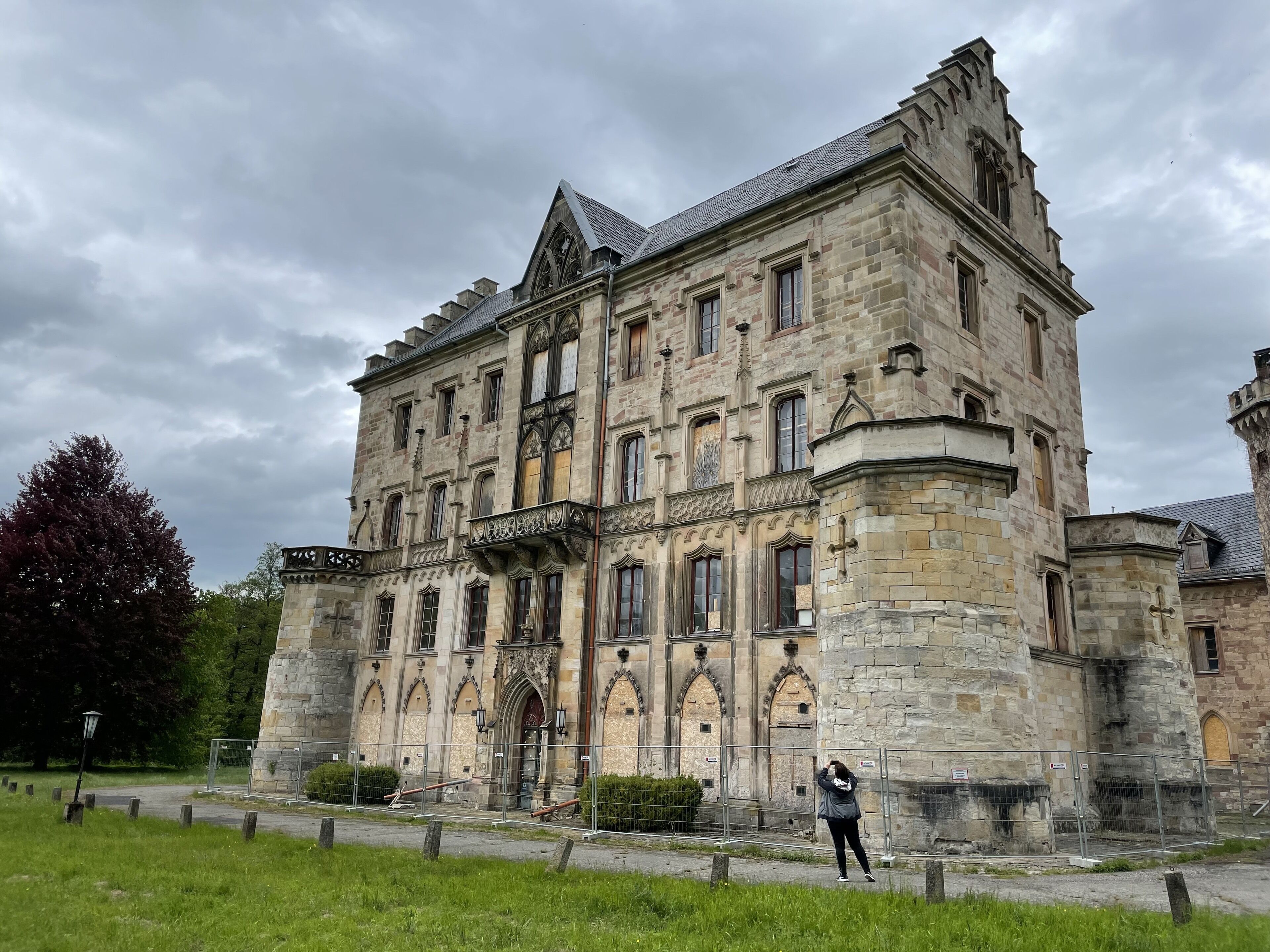 A historic stone building with arched windows and a prominent entrance.