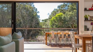 Relax on the outdoor deck with a comfortable sofa and dining area.