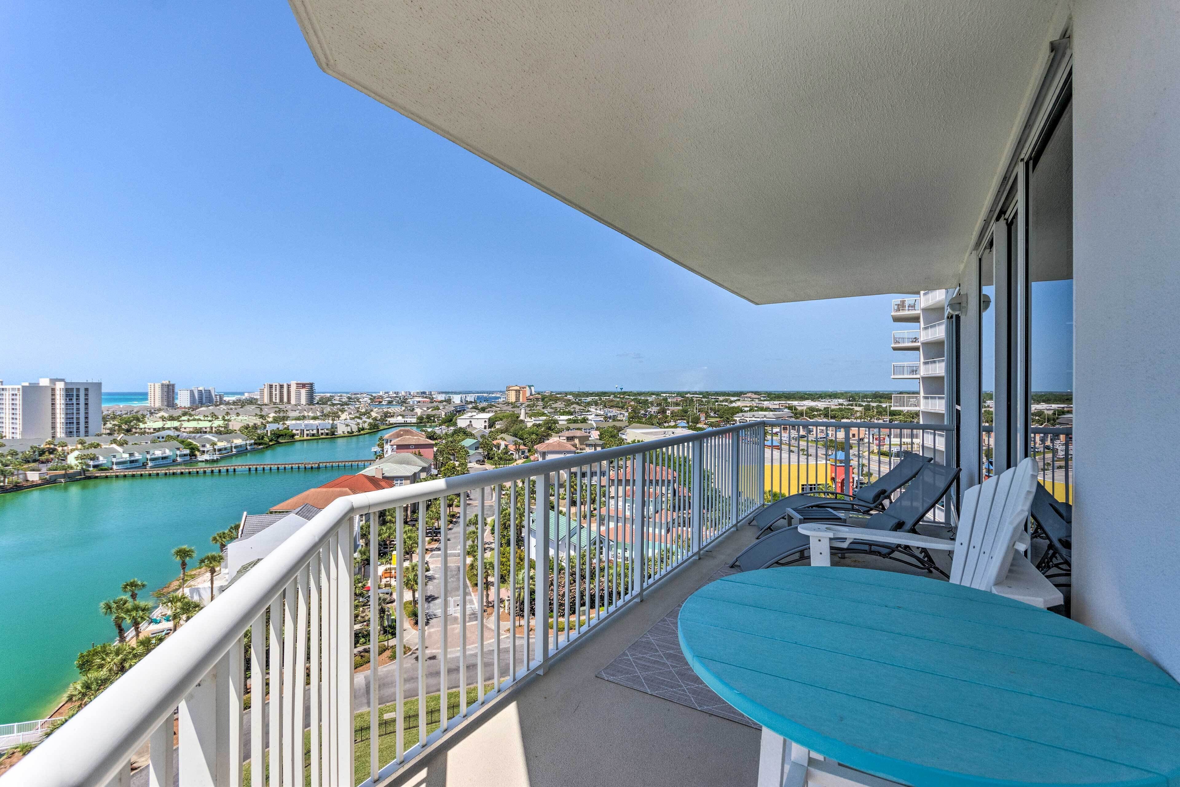 A balcony with a view of a marina and cityscape.