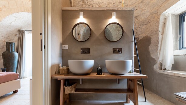 A bathroom with two large white basins, a wooden vanity, and two wall-mounted mirrors. - Holiday Home 'Trulli Terralunga' with Pool and Wi-Fi (Martina Franca)