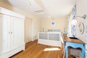 1 bedroom, desk, iron/ironing board, travel crib