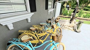A row of bicycles parked outside a building with a concrete porch. - Waterfront Home with Private Dock and Kayaks 4 Bedroom 2 Bath (Bradenton)