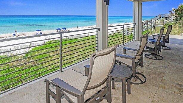 A covered outdoor seating area with a view of the beach and ocean. - Gulf Front With Private Pool- Serenity Blue by Royal Destinations (Santa Rosa Beach)