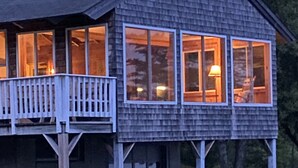 A two-story wooden house with a balcony and large windows. - Cozy, ocean-side retreat (Sedgwick)