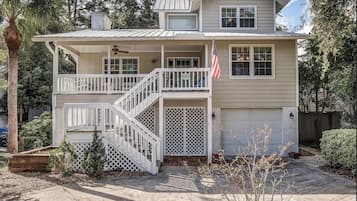 Stroll up to this charming home, featuring a cozy porch and a small deck, perfect for taking in the surroundings.