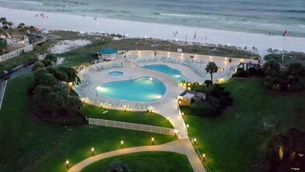 An aerial view of a resort with a large swimming pool, beach access, and a view of the ocean. - GORGEOUS BEACHFRONT VIEWS!! FREE BEACH SET UP, PRIVATE BEACH, POOL, SPA, AND GYM (Miramar Beach)