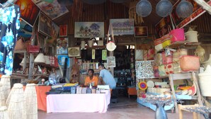 A market stall with various handmade items and a table with goods.