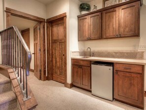 A kitchen with wooden cabinets, a stainless steel dishwasher, and a white countertop.