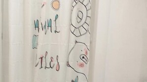 A bathroom with a white shower curtain featuring a bear design and the word "MILES" on it. - House with pool in Le Pradet quiet location  (Le Pradet)