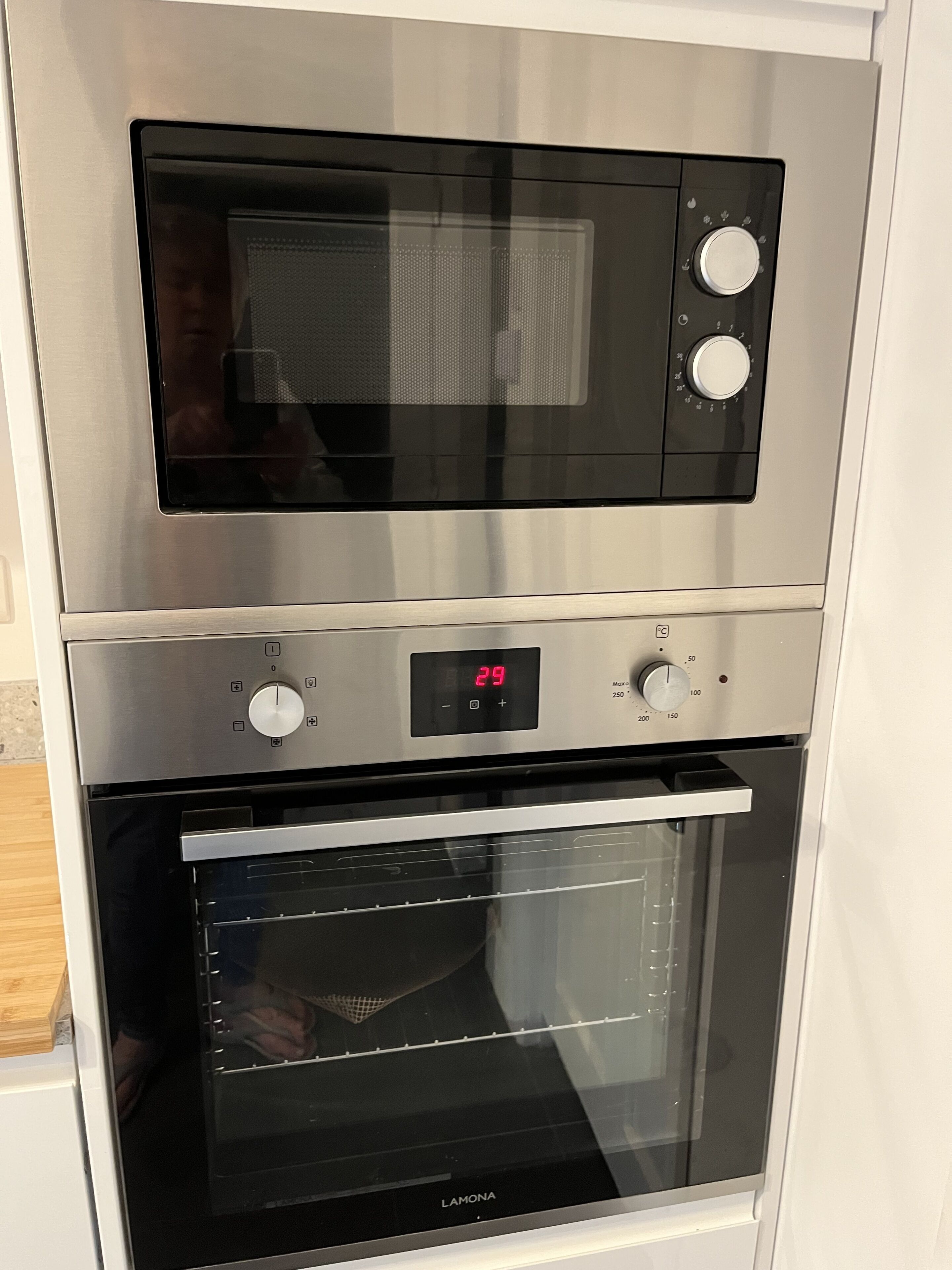 A kitchen with a built-in microwave and oven.
