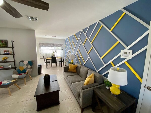 Relax in this stylish living room with a sofa, coffee table, and dining area.
