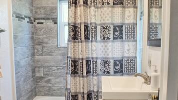 Combined shower/tub, hair dryer, towels, soap