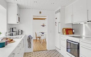 Enjoy cooking in this well-equipped kitchen with oven, coffee station, and ample utensils.