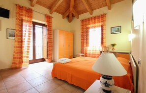 Cozy retreat with a comfortable bed, bedside lamp, and ample storage in a stylish room.