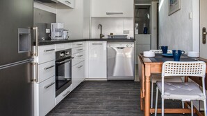 A compact kitchen with white cabinets, a Bosch dishwasher, and a coffee maker. - Beautiful apartment in noirmoutier-en-l'île (Noirmoutier-en-l'Île)