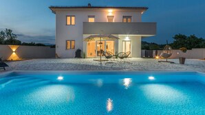 A modern two-story house with a swimming pool in the foreground. - Awesome home in Donja Jagodnja (Donja Jagodnja)