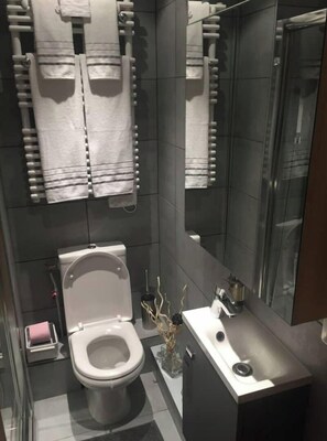 Douche, baignoire à remous, séchoir à cheveux, pantoufles