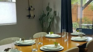 A dining area with a wooden table set for four, surrounded by chairs. - Hiker's Haven - The Start of a Beautiful, Adventurous and Peaceful Vacation (Sedona)