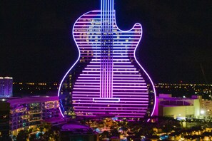 Experience the iconic guitar-shaped landmark under the night sky.