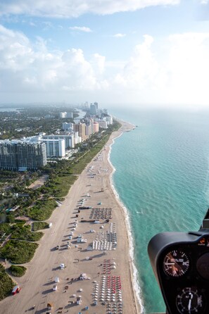 Overlooking the serene coastal cityscape, this beachfront location offers stunning views of the ocean and surrounding high-rise buildings.