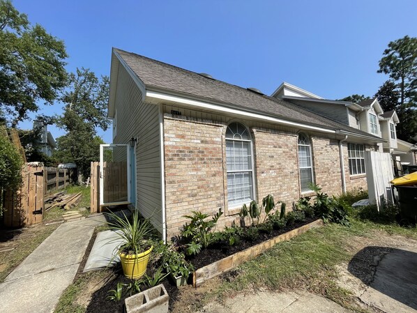 A two-story house with a brick facade and large windows. - Spacious Oversized Townhome! The Blue Water Bungalow (Fort Walton Beach)