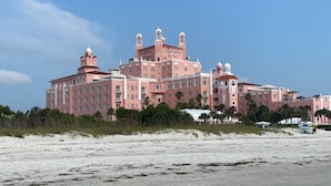 A large pink hotel with multiple towers and domes, located near a beach with sand and sparse vegetation. - Poolside Updated Studio Across from the Beach!! (St. Pete Beach)