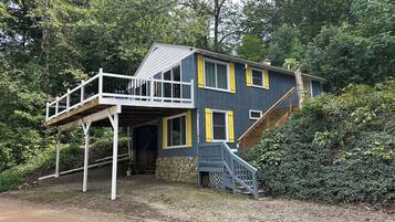 A two-story house with a balcony and a staircase leading to the upper level.