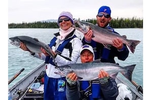 Guests can enjoy a successful fishing trip on the water, surrounded by a forested shoreline.