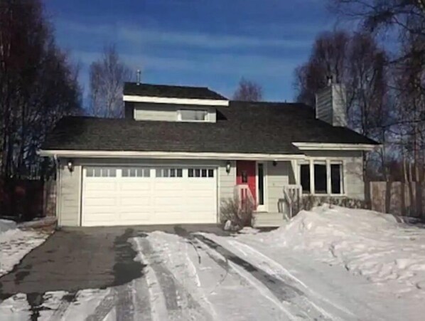 Stunning two-story home with a garage, sloped roof, and inviting front porch.