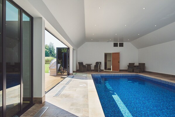 A heated pool, sun loungers