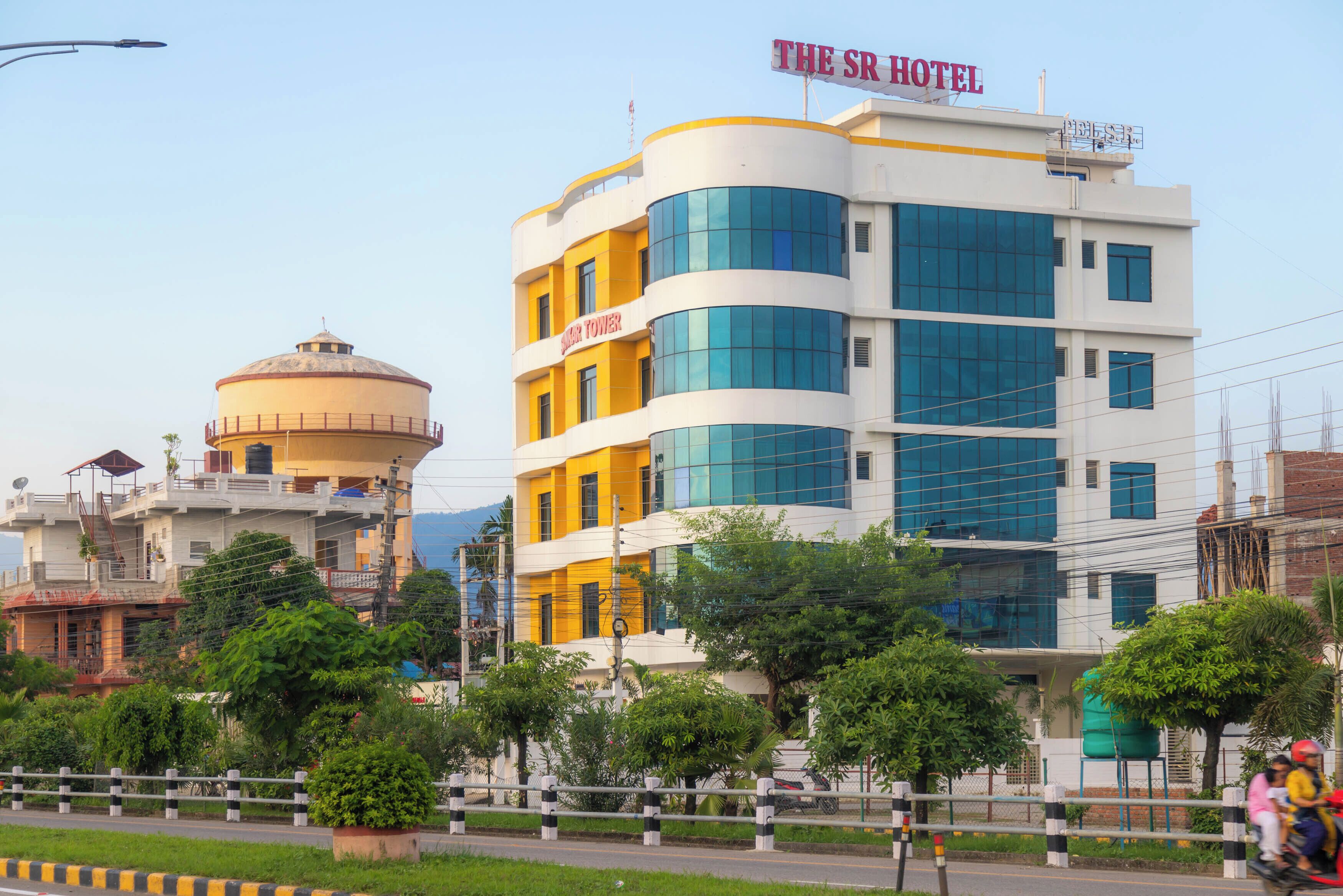 A multi-story hotel with a prominent sign reading "The SR Hotel".