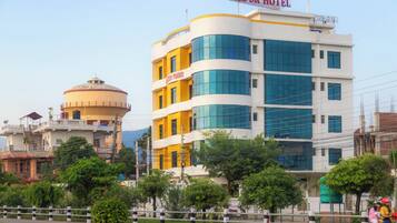 A multi-story hotel with a prominent sign reading "The SR Hotel".