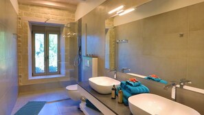 A modern bathroom with two sinks, a glass shower enclosure, and a large mirror. - Luxury villa with a fantastic view, the pool can be heated (Rethymnon)