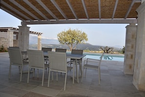 An outdoor patio with a pool, stone pillars, and a view of mountains. - Luxury villa with a fantastic view, the pool can be heated (Rethymnon)