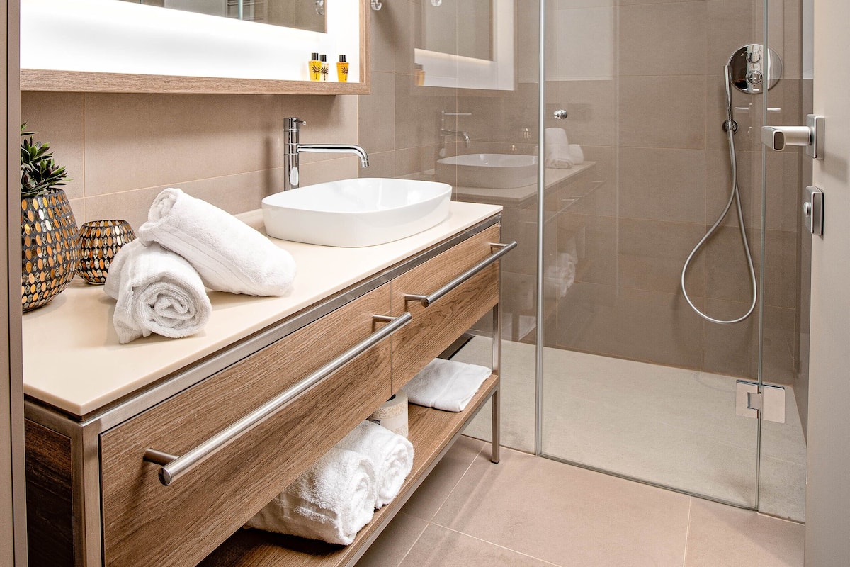 Shower, rainfall showerhead, designer toiletries, hair dryer